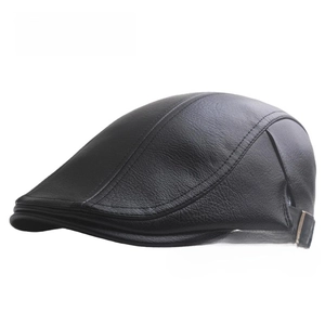 Detailed view of black leather beret featuring natural grain texture and metal side buckle