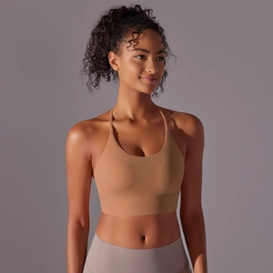 Detail of nude racerback sports bra showing thin straps and breathable stretch fabric