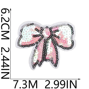 Macro detail of a pink and white sequined bow patch measuring 7.3cm by 6.2cm