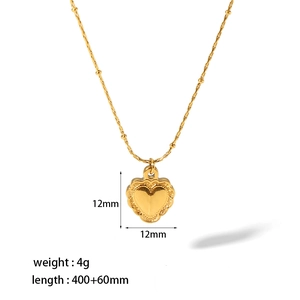 Detail of 18K gold heart pendant with scalloped edges and adjustable bead chain