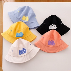 Flat lay of colorful kids cotton bucket hats with GOODLUCKY text and cartoon rabbit ears