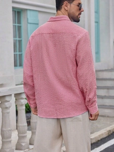 Detail of men's red and white striped seersucker shirt showing the back cut and texture