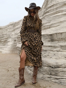 Close-up of leopard print maxi dress with brown leather belt and western style accessories