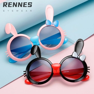 Detail of round kids sunglasses with rabbit ears and bow decorations in multiple colors