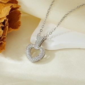 Macro view of heart pendant necklace with AAA cubic zirconia on white stone