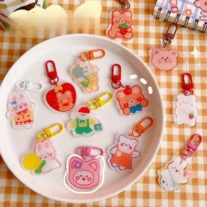 Close-up of cute acrylic animal keychains featuring bears and rabbits with colored D-rings