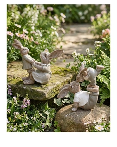 Detailed close-up of resin Easter bunny statues with stone texture in a garden setting