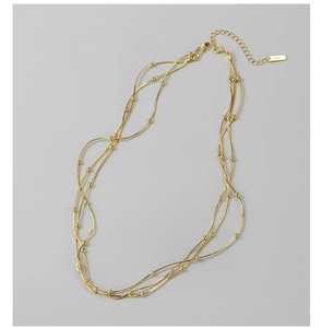Close-up of S925 sterling silver triple-layer snake chain with gold finish and beads