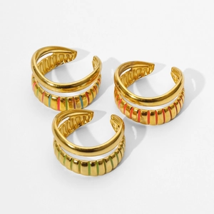 Macro detail of gold plated open rings with colorful striped enamel textured patterns