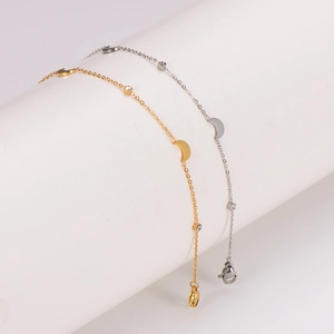 Gold and silver minimalist moon anklets with star charms on white display stands