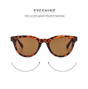 Detail of tortoise shell sunglasses with oversized frames and dark brown lenses