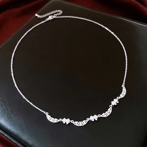 Elegant silver bow pendant necklace with adjustable chain on black leather background