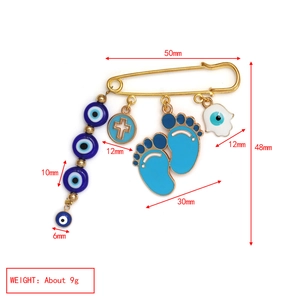 Detailed size map of golden safety pin brooch with blue evil eye and hamsa charms