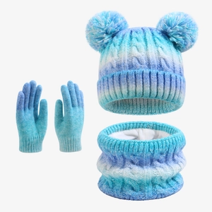 Detailed view of the gradient blue knit beanie with soft white fleece lining and poms
