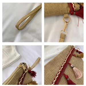 Detail of woven straw envelope clutch featuring colorful tassels and ethnic embroidery