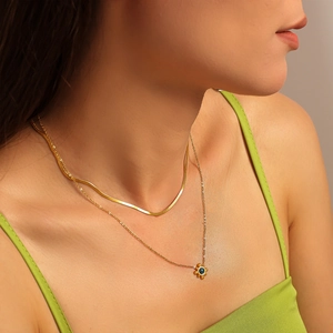 Double-layered 18k gold plated sun flower necklace set with blue gemstone on model