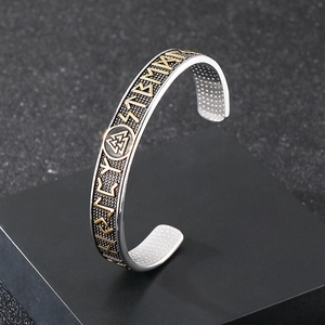 Detailed side view of Viking rune cuff bracelet on black geometric display stand