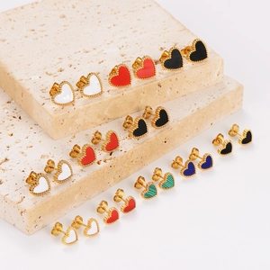 Mini heart stud earrings set in colorful enamel and gold finish on stone props
