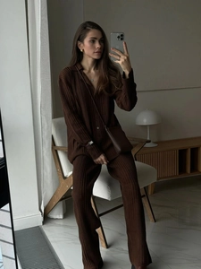 Close-up of dark brown long-sleeved polo shirt and trousers set with vertical ribbed texture