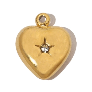 Detailed macro of a gold heart pendant with star-set zircon and polishing finish