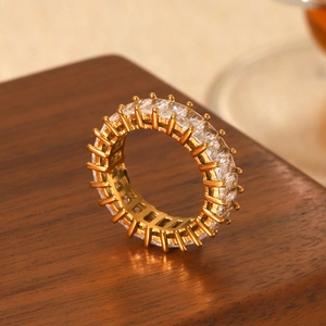 Gold stainless steel ring with rectangular cubic zirconia stones in 45-degree side view