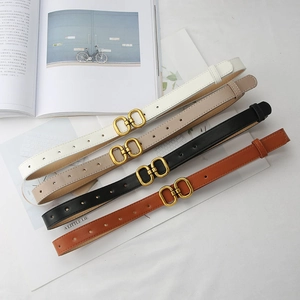 Detail view of thin faux leather belts in four colors with golden double ring buckles