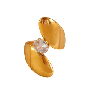 Detail of gold irregular ring featuring a four-prong set oval cubic zirconia centerpiece