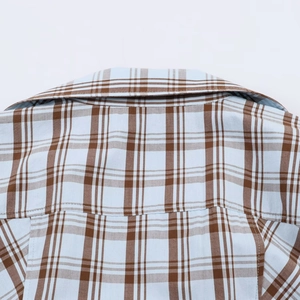 Detail of light blue and brown plaid shirt showing high-quality collar stitching