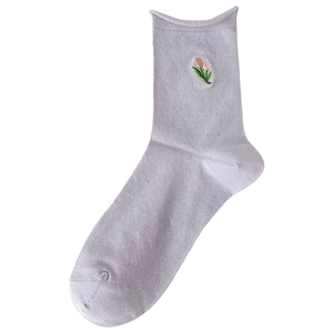 Lavender cotton crew socks with delicate tulip embroidery in a minimalist flat lay