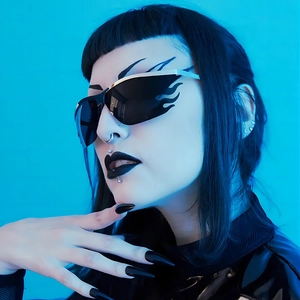 Cyberpunk flame shaped sunglasses with silver metal frame and dark lenses worn by a model