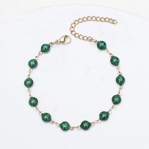 Detail of 18K gold plated chain bracelet with 14 sparkling green glitter beads and lobster clasp