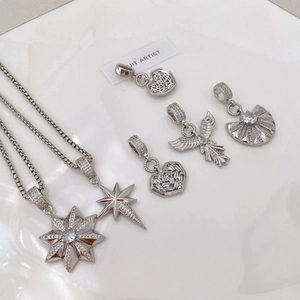 Silver star pendant necklace with cubic zirconia pave and dainty heart wing charms