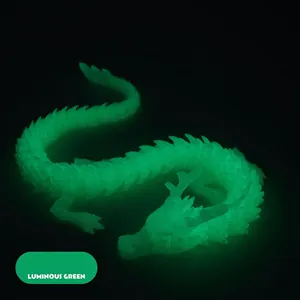 Detailed close-up of 3D printed jointed dragon featuring bright luminous green glow in dark