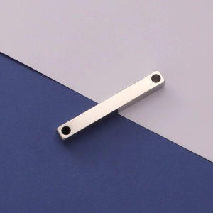 Detailed view of silver rectangular titanium steel bar pendant with double holes on blue background