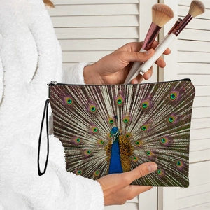 Women's peacock print makeup bag with zipper and hand strap for travel and home use