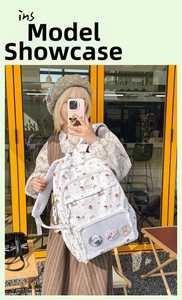 Detailed view of white nylon backpack featuring colorful cartoon dog prints and transparent pocket