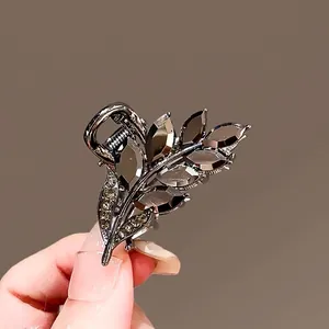 Vintage silver leaf hair claw clip with dark grey marquise gems and yellow rhinestones
