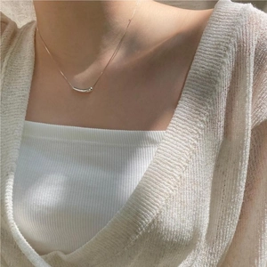 Close-up of minimalist S925 sterling silver water drop pendant on a delicate chain