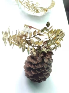 Detail of a golden laurel leaf headband with intricate metallic texture and vintage design