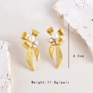 Detailed view of gold bow earrings with white pearls and 4.2cm size measurement label