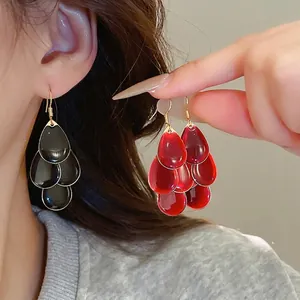 Elegant multi-layer water drop tassel earrings in black and red resin with gold hooks