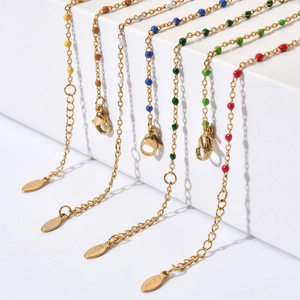 Detail of gold stainless steel bracelet with colorful beads and adjustable lobster clasp
