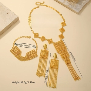 Detailed view of gold plated layered jewelry set with square charms and long chain tassels