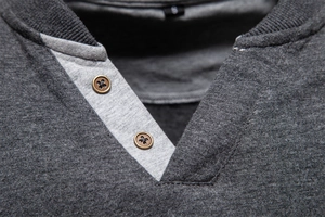 Detailed close-up of a men's V-neck long sleeve tee with two-button contrast collar