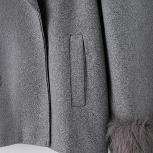 Deep grey wool coat with elegant faux fur cuffs and side pockets for winter warmth