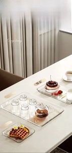 Close-up of thick transparent acrylic serving trays in three sizes for home snacks