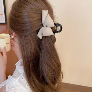Elegant beige bow hair claw clip with black resin shark clip for women's hairstyle
