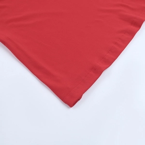 Close-up of high-quality stitching and fabric texture on red sequin dress hemline