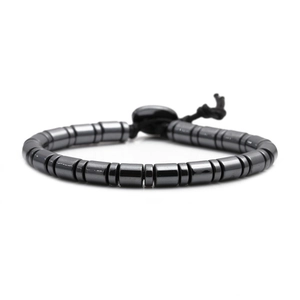 Polished dark grey hematite cylinder bead bracelet for men on a white background