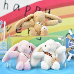 Detail view showing three colorful cute bunny plush keychains in brown pink and white